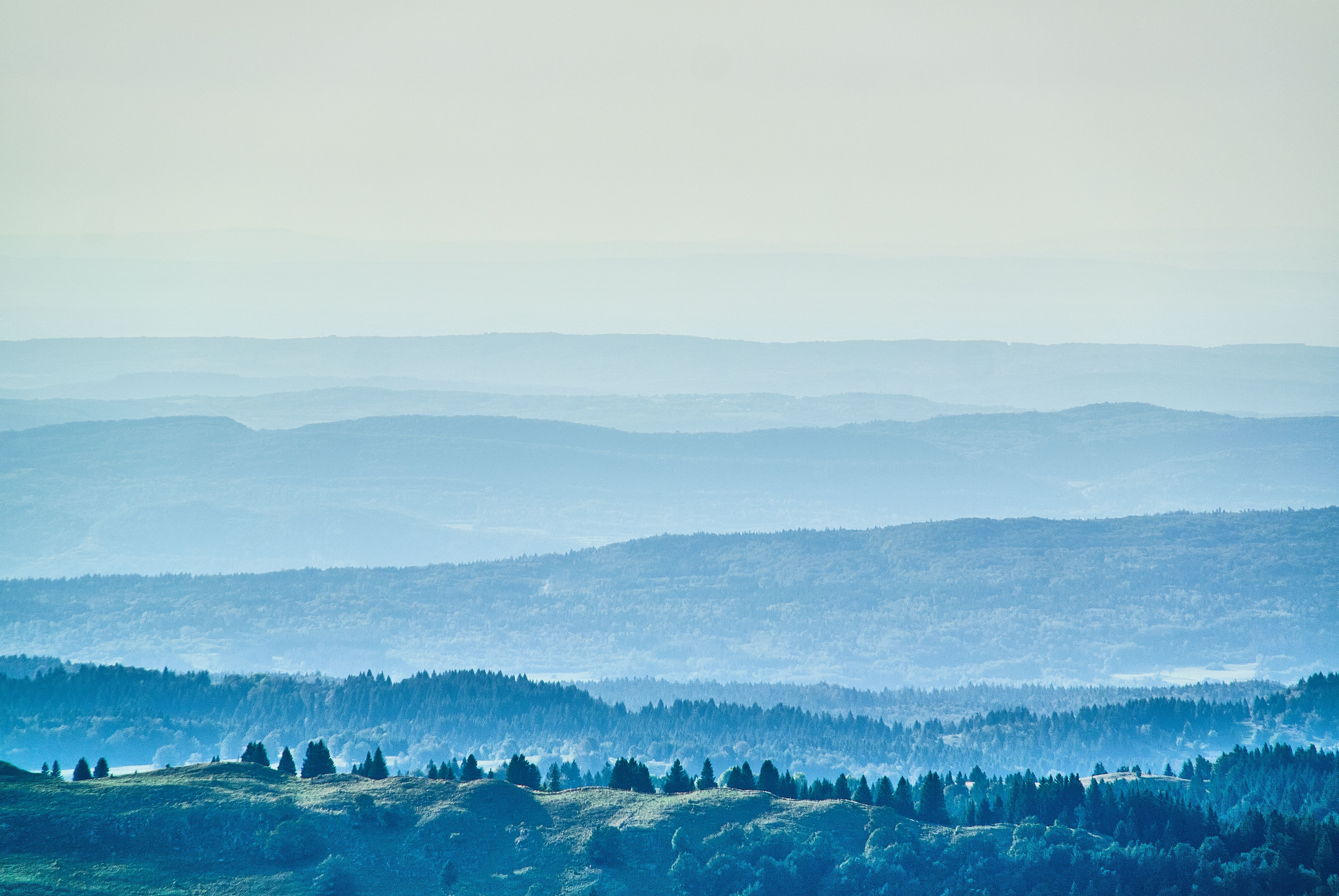 Layered blue-green hills receding into hazy distance